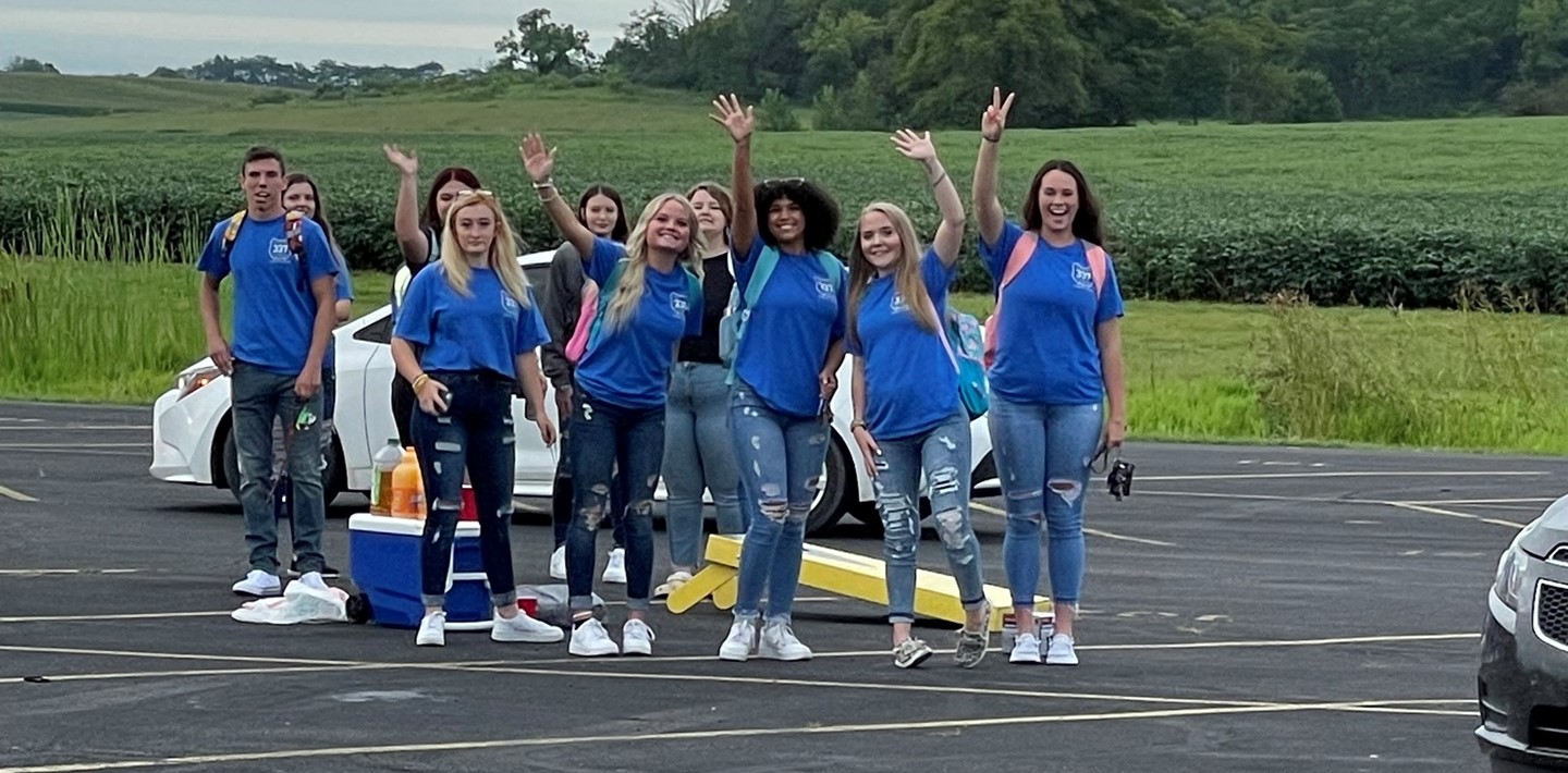 Senior students on the first day of school gathered in the parking lot in the blue Mason Cordell shirts.