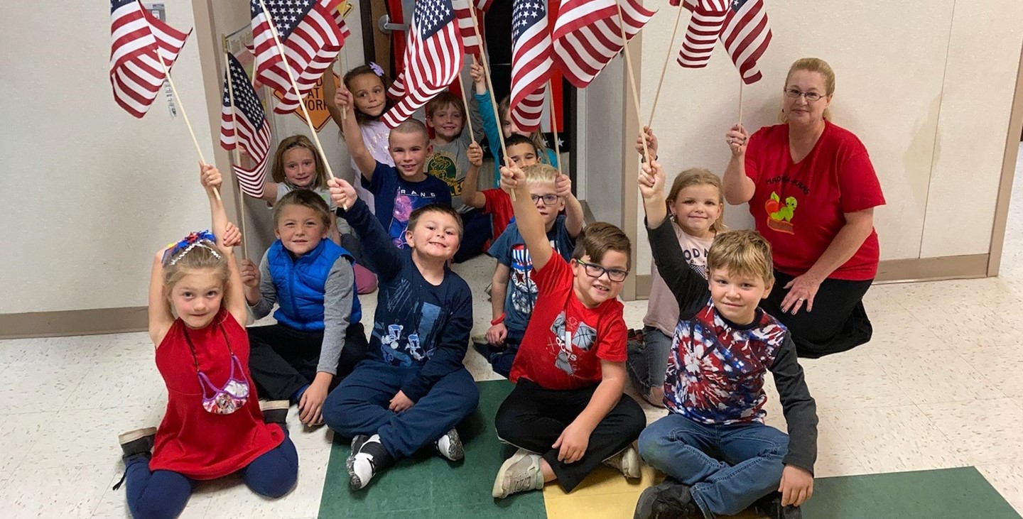 Mrs. Weimer&#39;s class celebrating Veterans Day holding their flags!