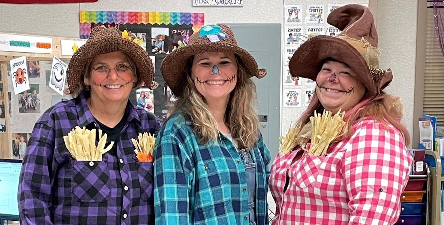 Staff dressed as scarecrows for Halloween