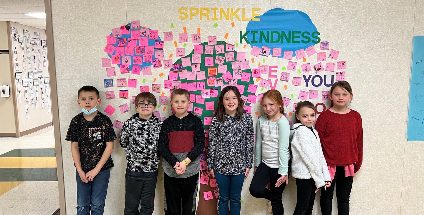 Kids in front of the Kindness wall during Kindness week.
