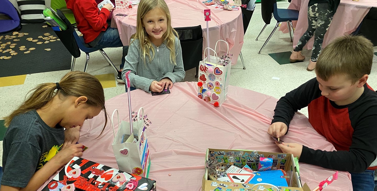 Kids in Mrs. Dresch&#39;s class working on a craft during the Valentine&#39;s party