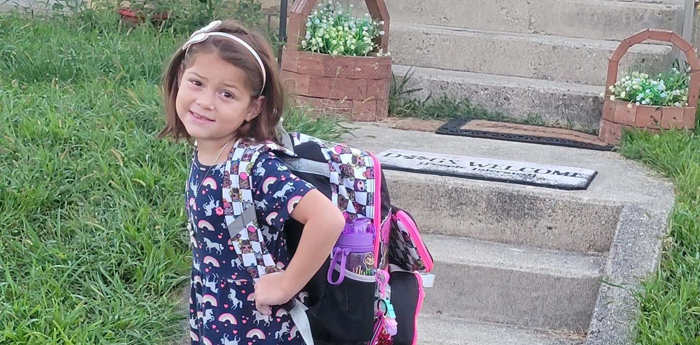 Student posing with her backpack on the first day of school