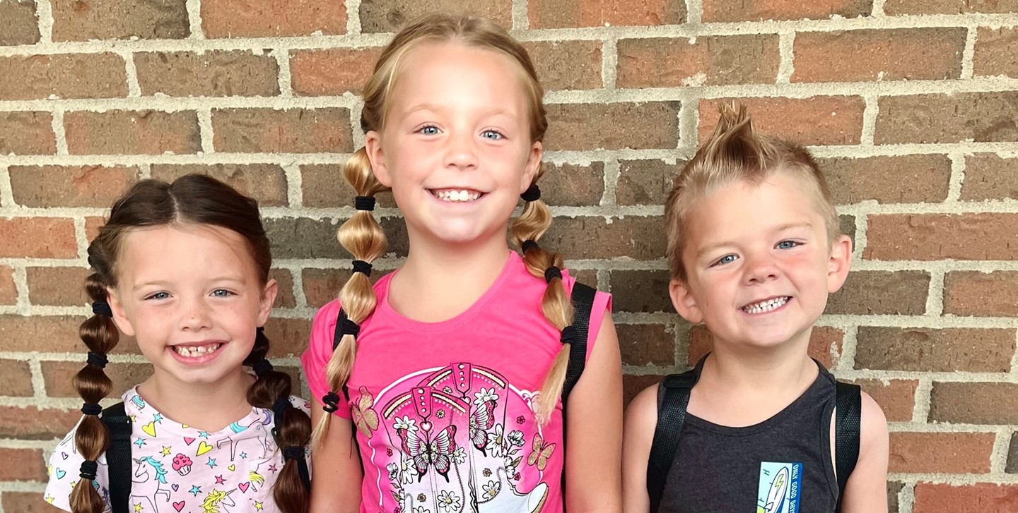Siblings posing for a picture on the first day of school
