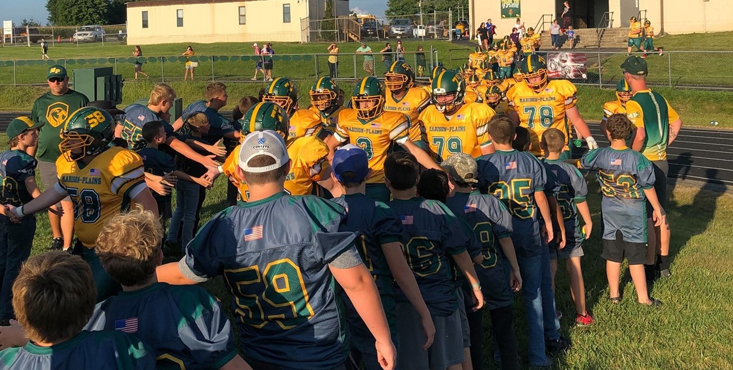 GEYSA football team along with the Varsity team